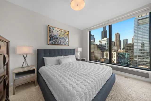 a bedroom with a large bed and a large window