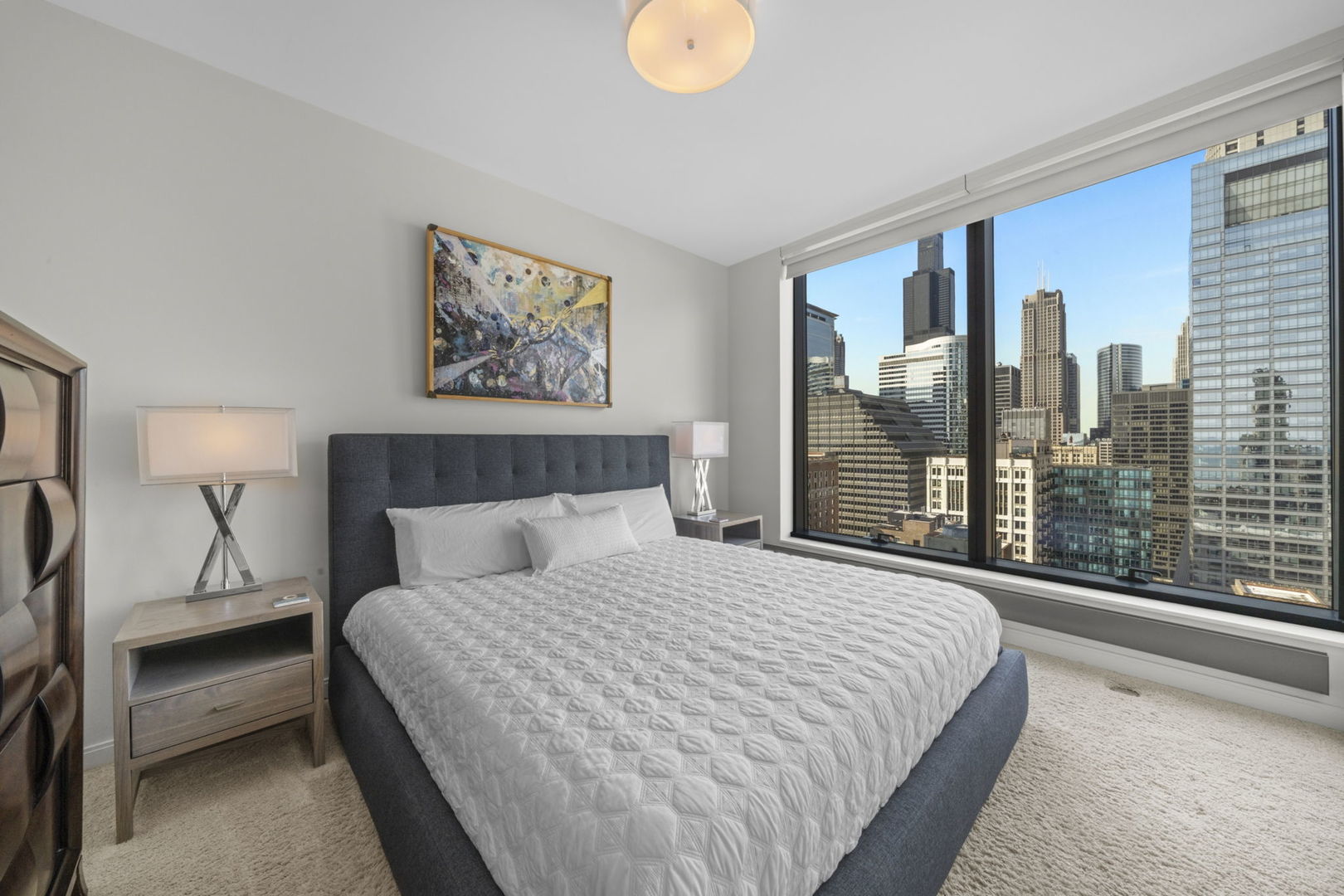 60 East Monroe Street, Unit 2606 Chicago, IL 60603 - Photo 17 of 34 a bedroom with a large bed and a large window