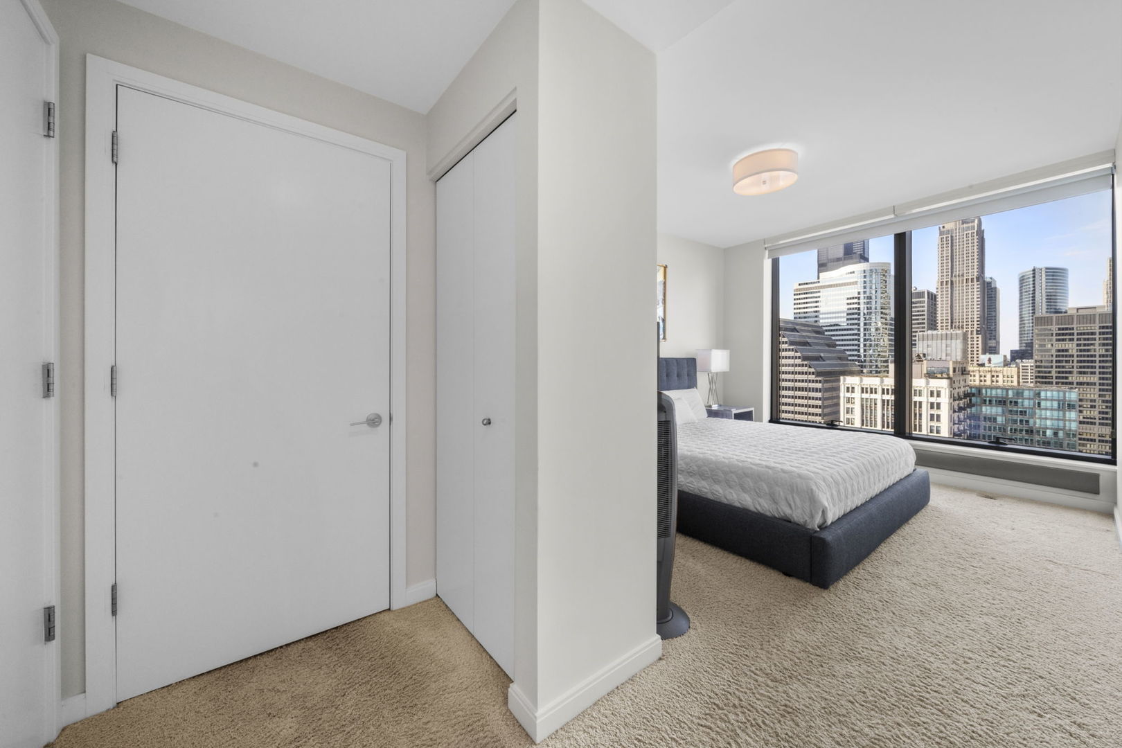 60 East Monroe Street, Unit 2606 Chicago, IL 60603 - Photo 19 of 34 a bedroom with a bed and a large window