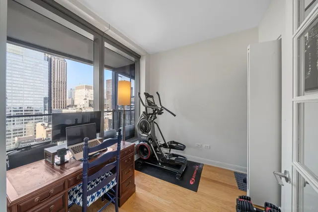 a room with gym equipment and large windows