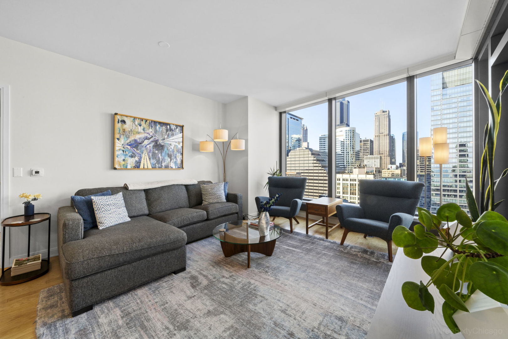 60 East Monroe Street, Unit 2606 Chicago, IL 60603 - Photo 3 of 34 a living room with furniture plant and a large window