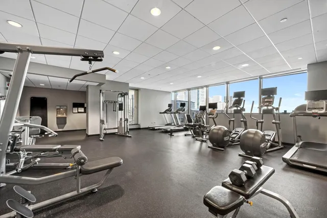 a room with gym equipment and lots of equipment