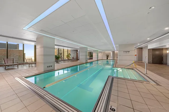 a room with pool table and windows