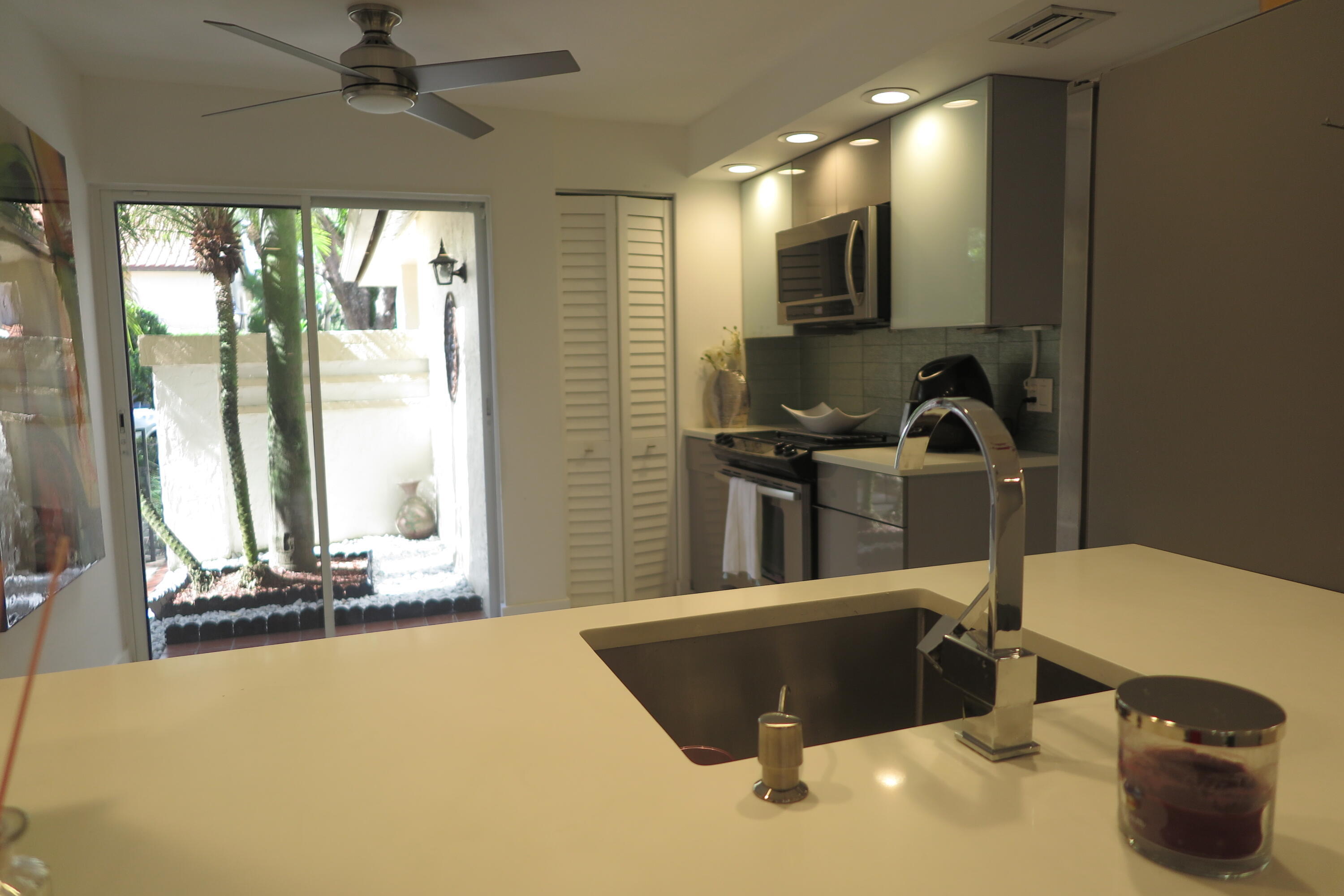 7875 La Mirada Drive Boca Raton, FL 33433 - Photo 11 of 31 a kitchen with a sink a counter top space and a window