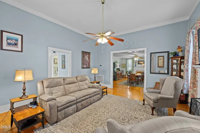 a living room with furniture a lamp and a chandelier
