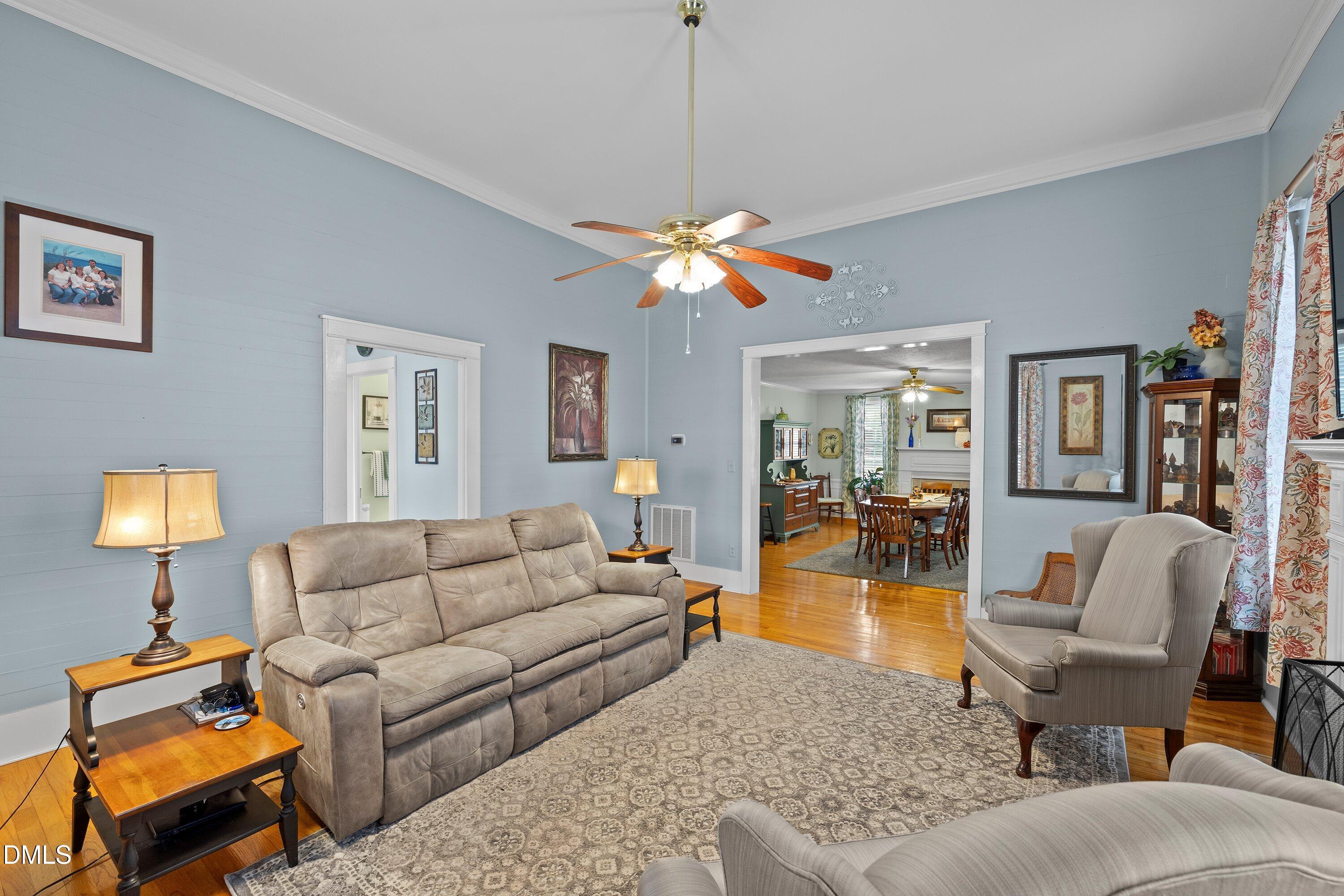 89 Bailey-Boykin Road Selma, NC 27576 - Photo 11 of 48 a living room with furniture a lamp and a chandelier