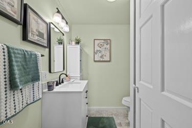 89 Bailey-Boykin Road Selma, NC 27576 - Photo 13 of 48 a bathroom with a sink mirror and a toilet