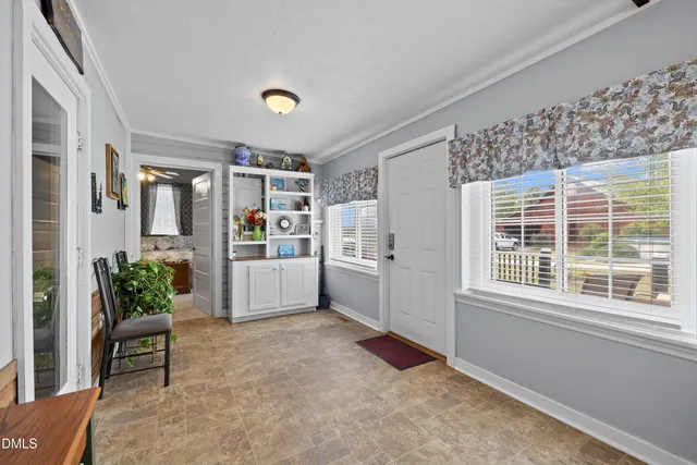 a living room with furniture and potted plant