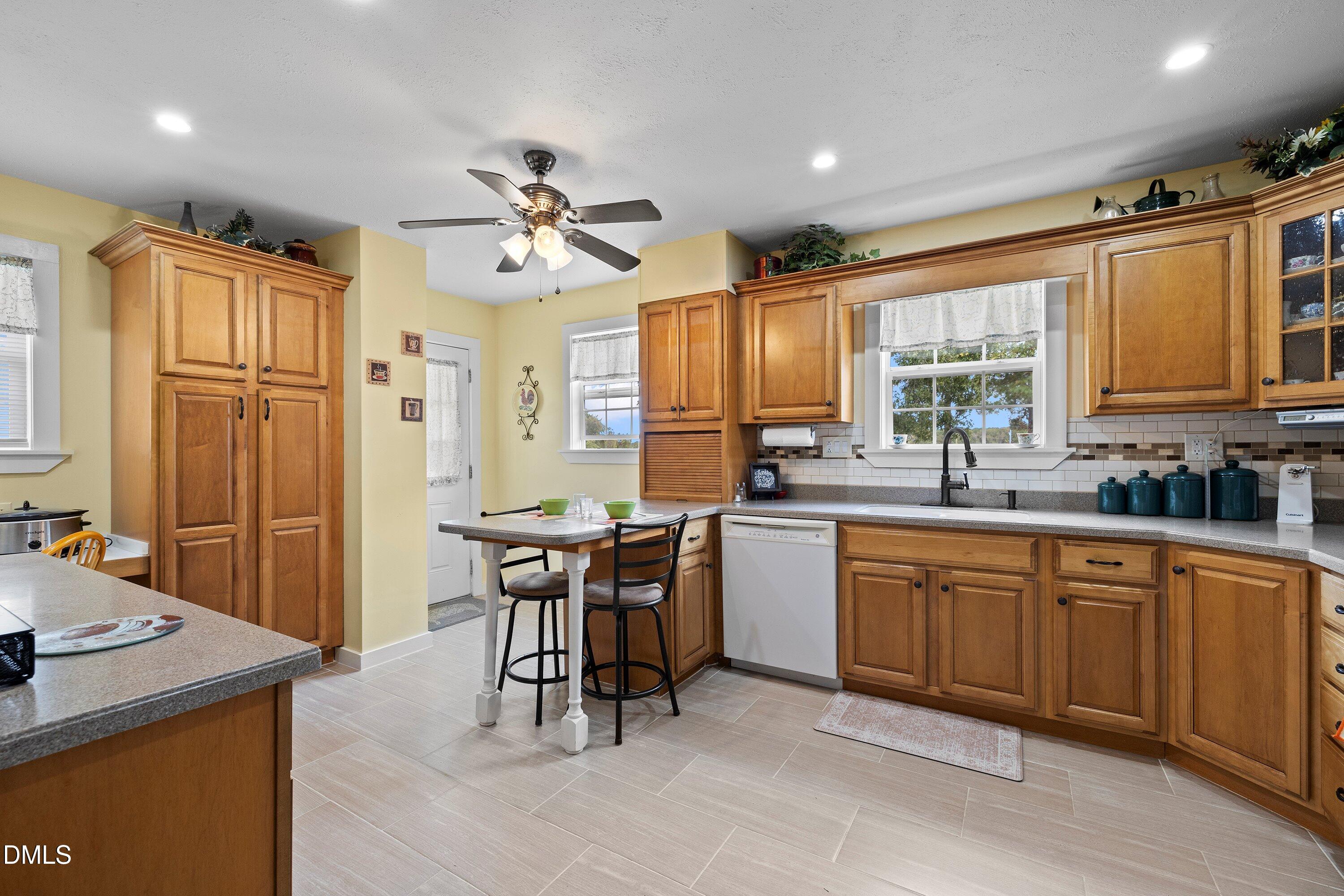 89 Bailey-Boykin Road Selma, NC 27576 - Photo 25 of 48 a kitchen with granite countertop cabinets stainless steel appliances a sink and a window