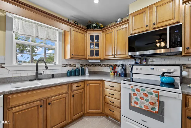 a kitchen with stainless steel appliances a stove microwave and cabinets