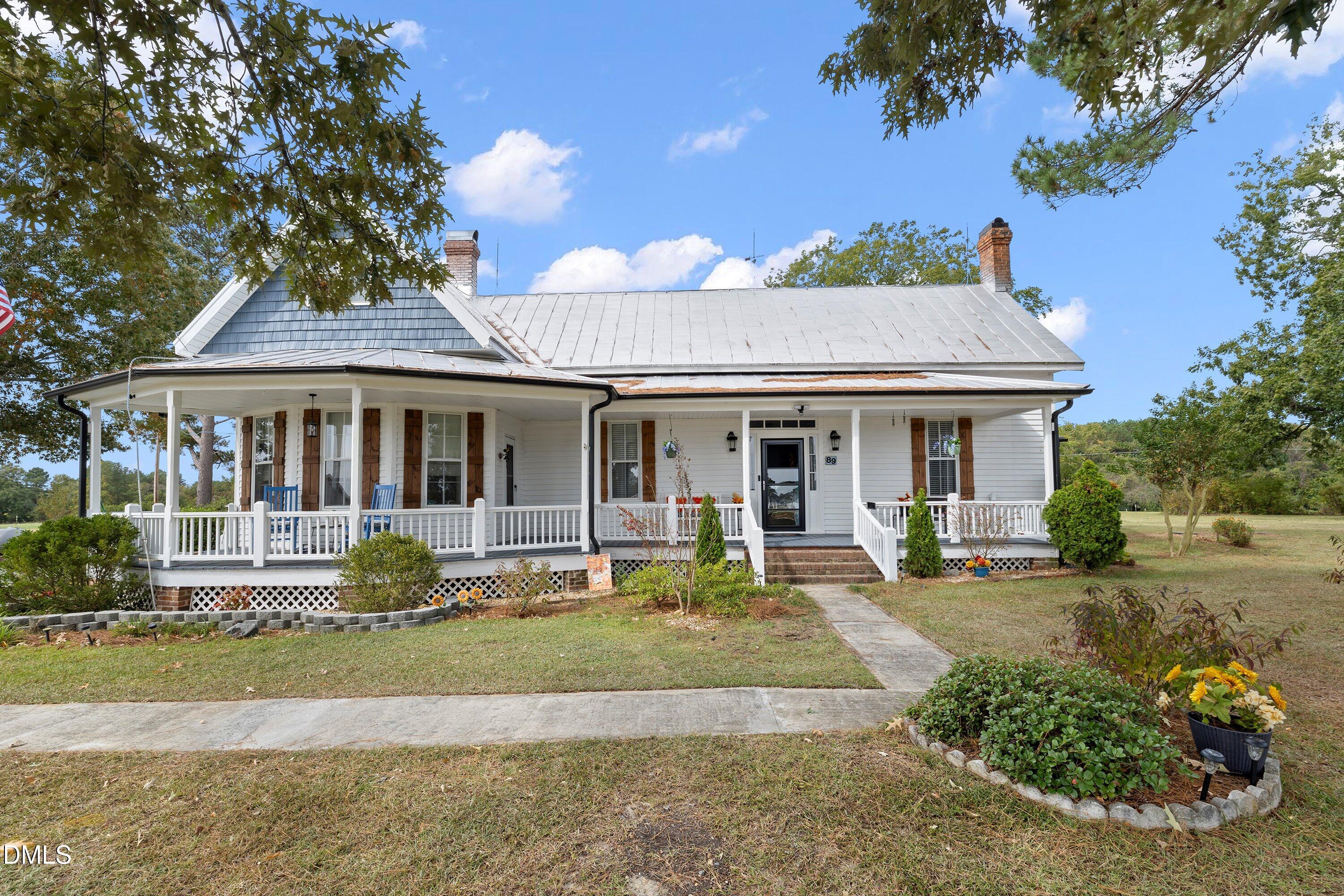 89 Bailey-Boykin Road Selma, NC 27576 - Photo 3 of 48 a front view of a house with a yard table and chairs