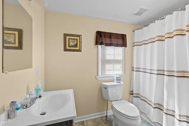 a white toilet sitting next to a bathroom sink
