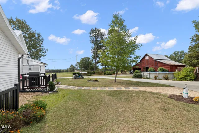 a view of outdoor space with green field and trees