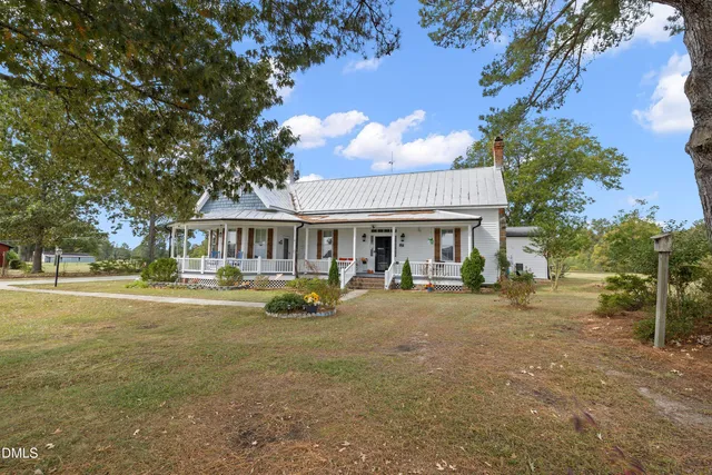 a front view of a house with a garden and porch