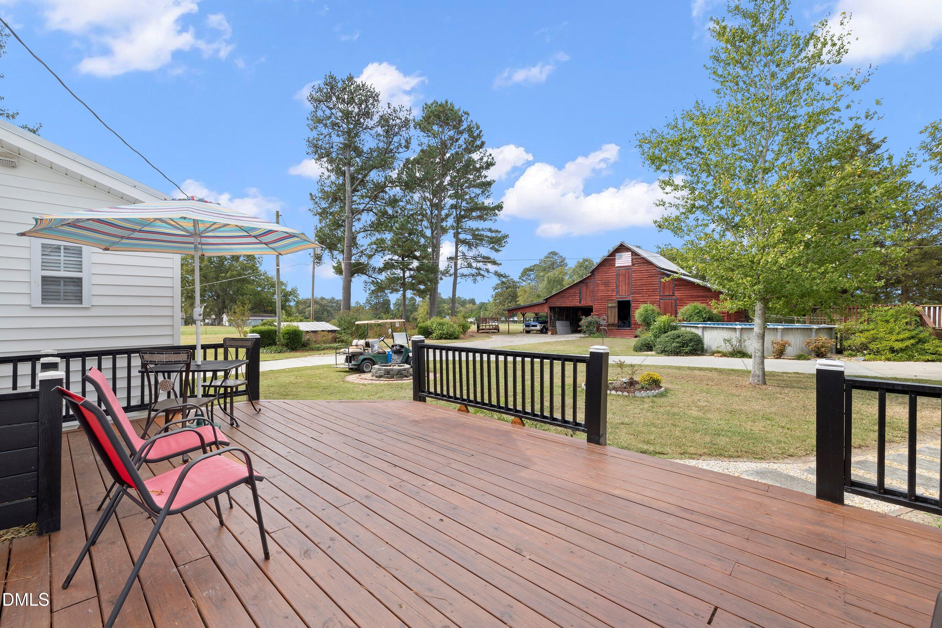 89 Bailey-Boykin Road Selma, NC 27576 - Photo 41 of 48 a view of a roof deck with table and chairs and wooden floor