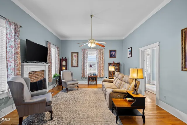 a living room with furniture a flat screen tv and a fireplace