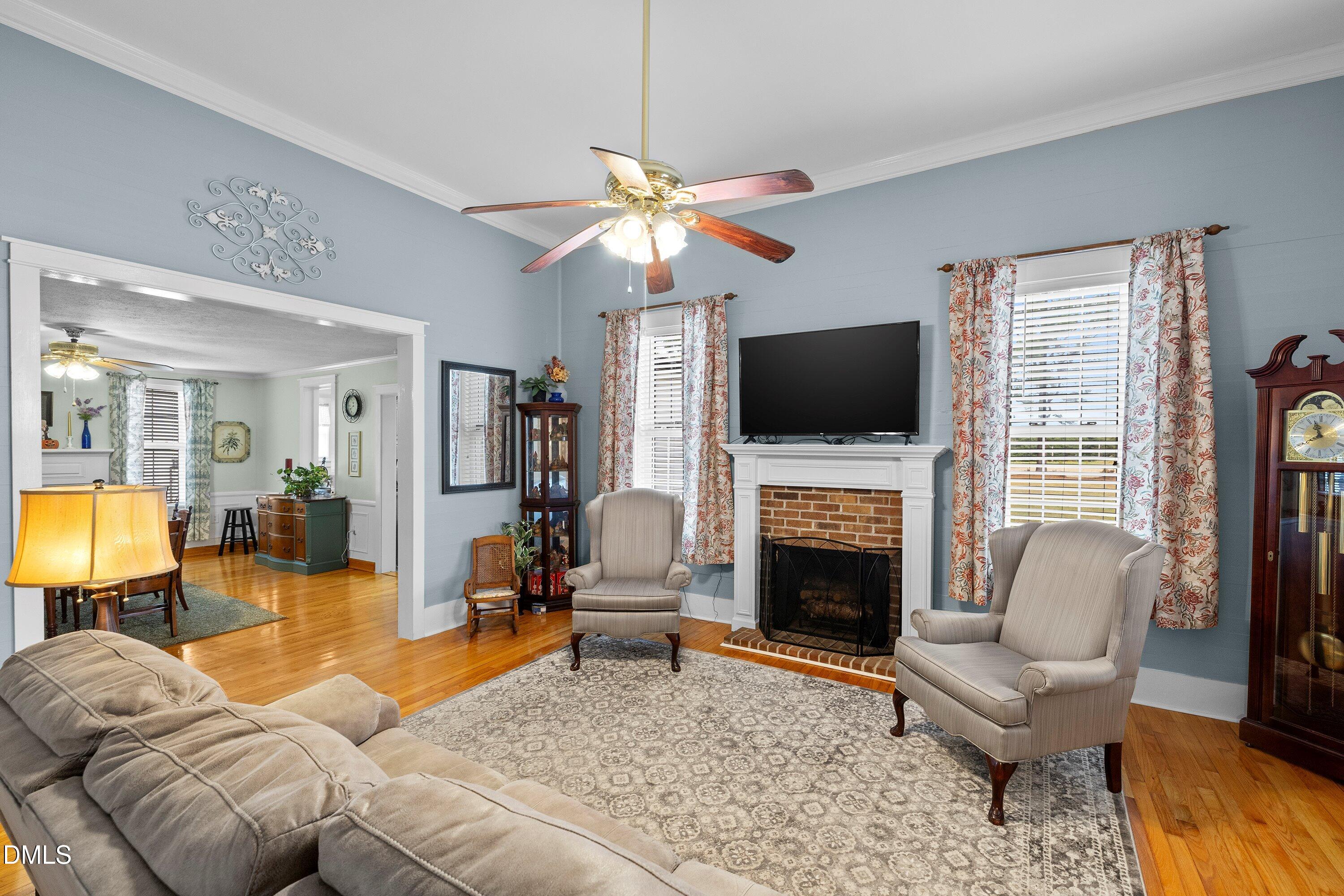 89 Bailey-Boykin Road Selma, NC 27576 - Photo 10 of 48 a living room with furniture a fireplace and a flat screen tv