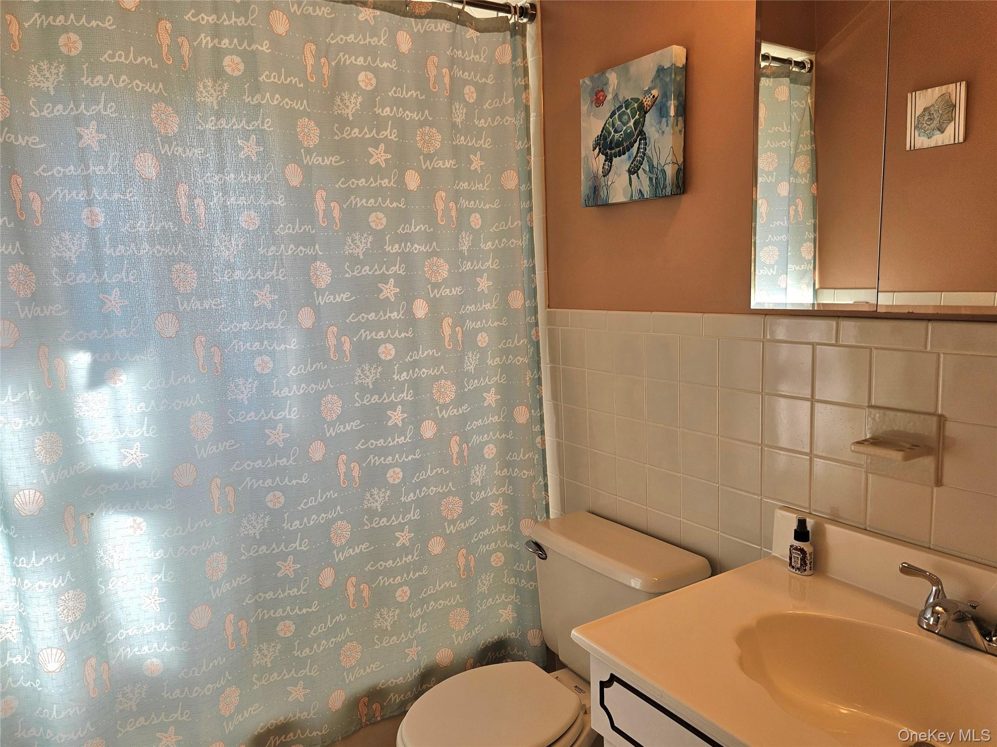 3650 Bay Shore Road Greenport, NY 11944 - Photo 28 of 30 a bathroom with a sink and a mirror