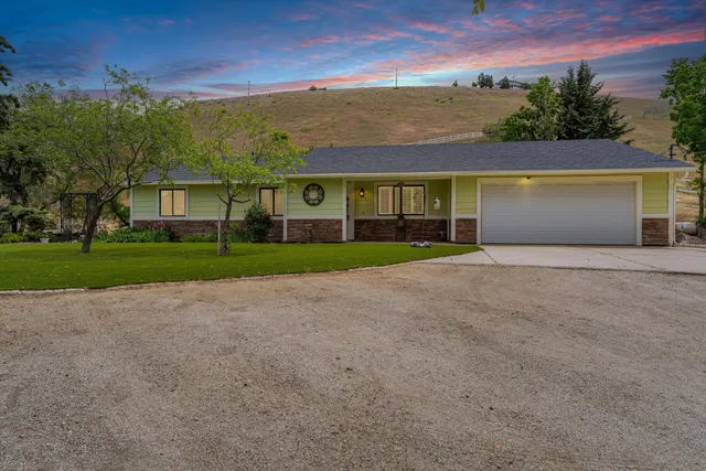 front view of a house with a yard and a garage