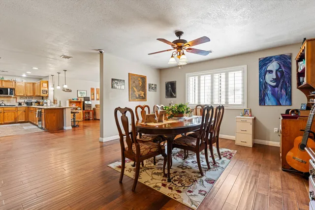 a view of a a dining room with furniture window and wooden floor