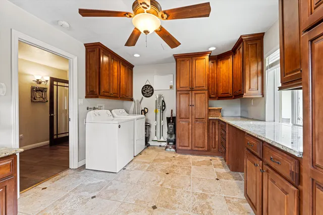 a kitchen that has a lot of cabinets in it and wooden floors