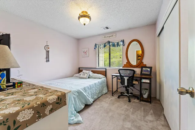 a bedroom with a bed and a chandelier