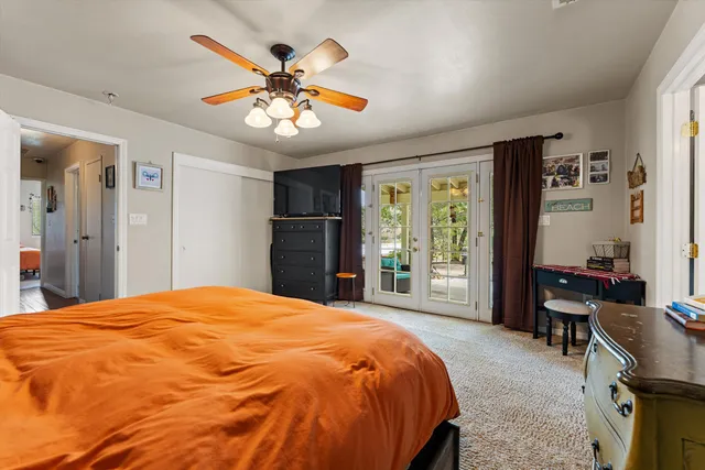 a bed sitting in a bedroom next to a window