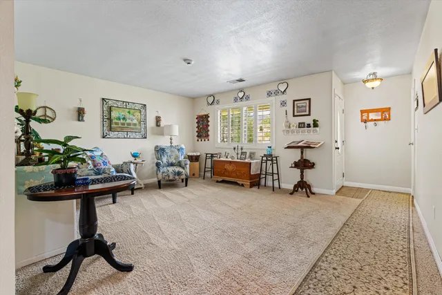 a view of a livingroom with workspace and a window
