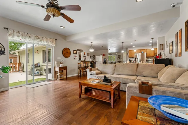 a living room with furniture and a wooden floor