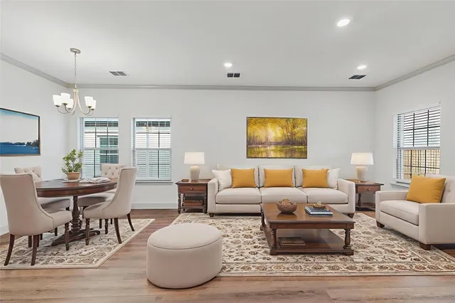 a living room with furniture and a wooden floor