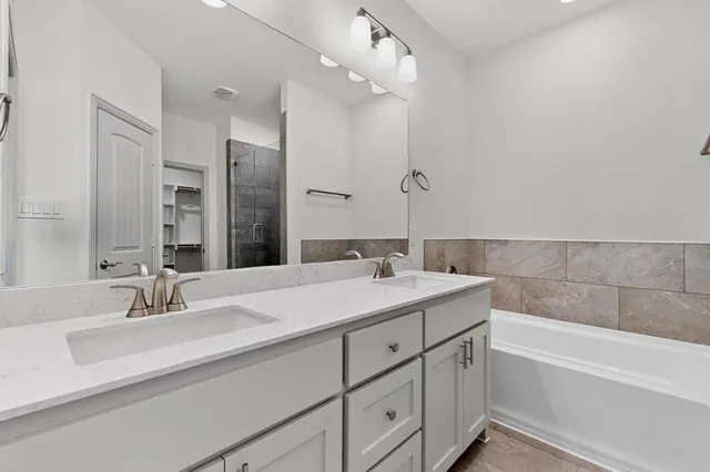 a view of kitchen with granite countertop stainless steel appliances refrigerator oven stove and cabinets