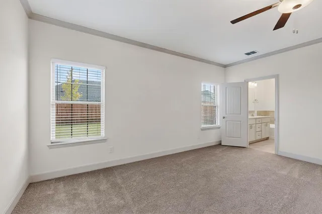 a view of a livingroom with a ceiling fan and wooden floor