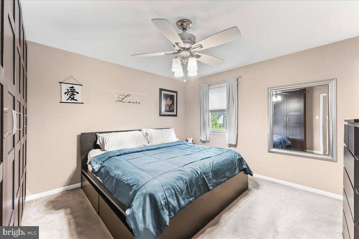 208 Rambling Way Springfield, PA 19064 - Photo 18 of 39 a bedroom with a large bed and a chandelier