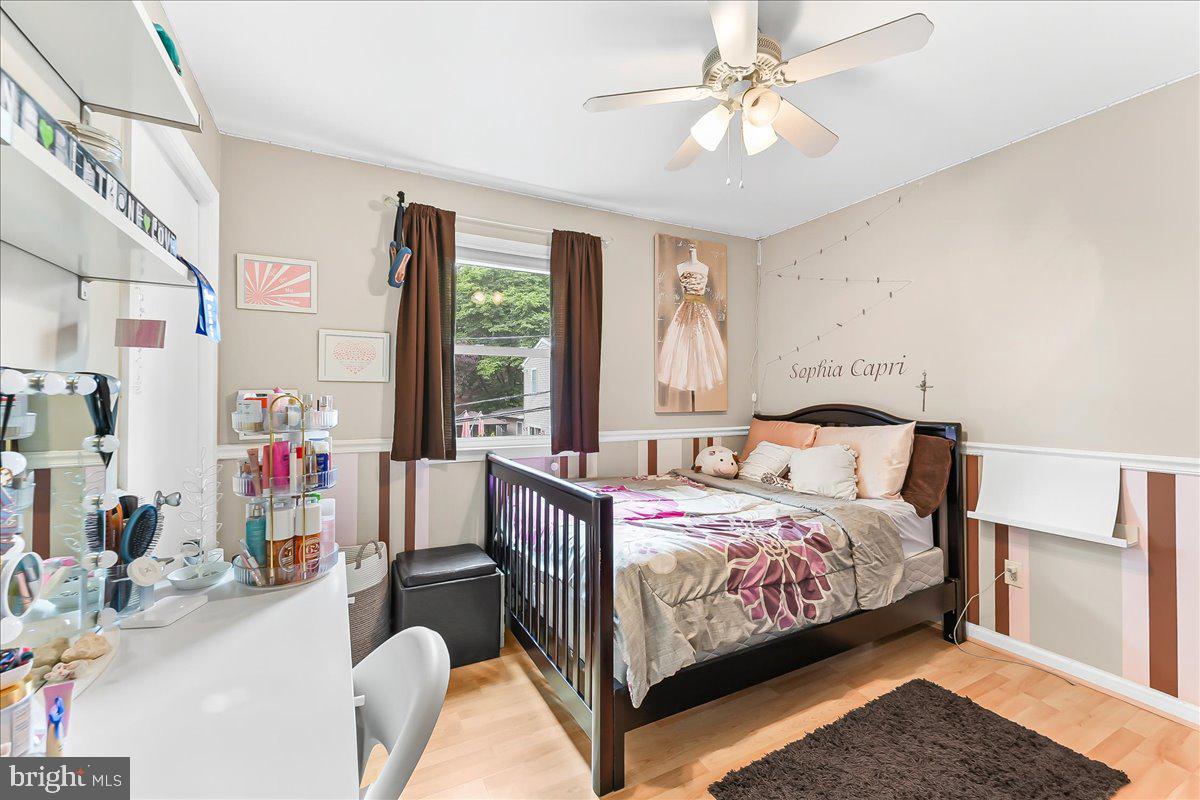 208 Rambling Way Springfield, PA 19064 - Photo 23 of 39 a bedroom with a bed and a chandelier