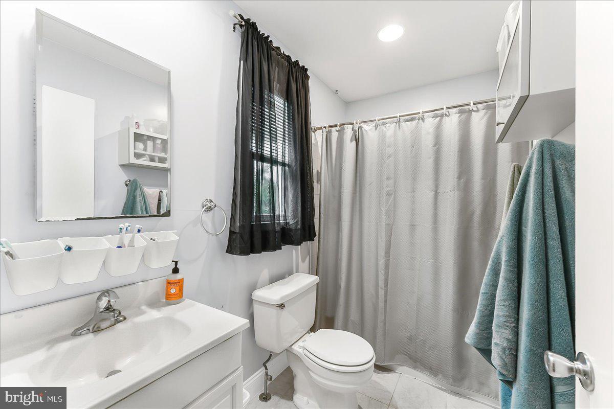 208 Rambling Way Springfield, PA 19064 - Photo 25 of 39 a bathroom with a sink a toilet and shower