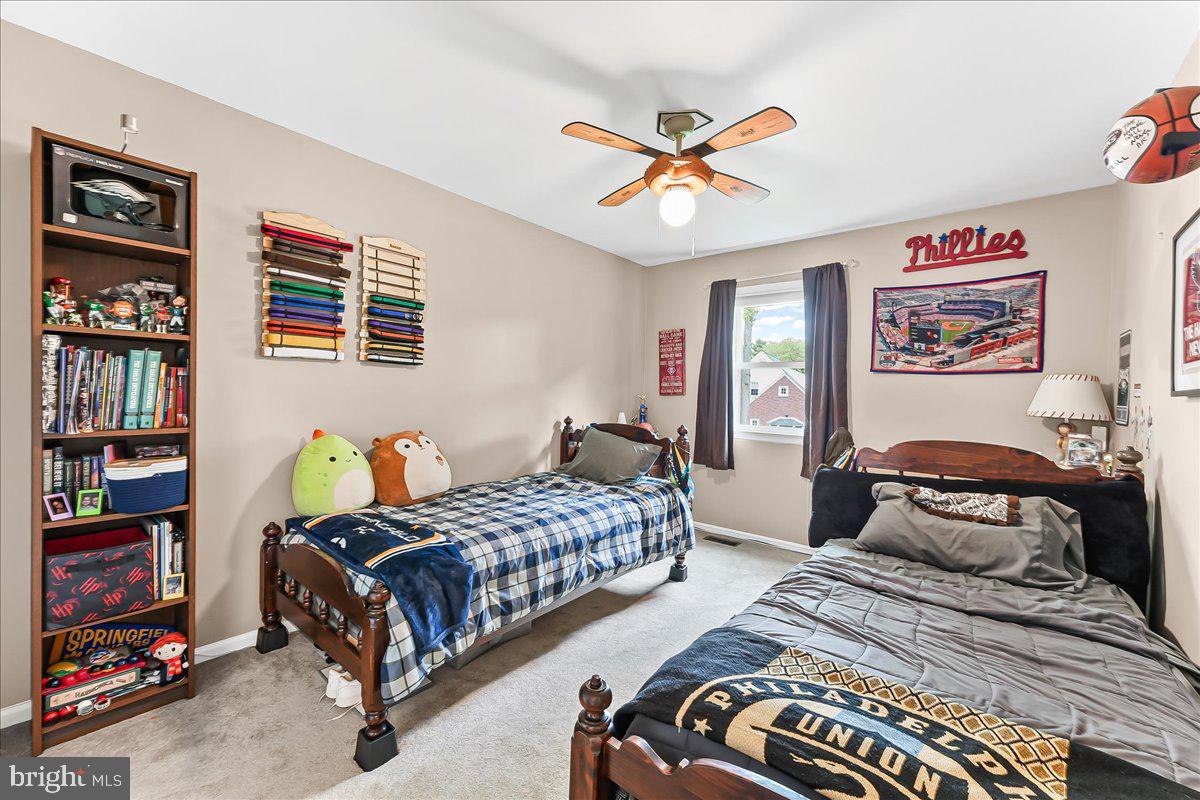 208 Rambling Way Springfield, PA 19064 - Photo 26 of 39 a bedroom with a bed and a chandelier