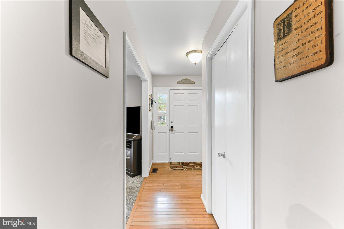 208 Rambling Way Springfield, PA 19064 - Photo 5 of 39 a view of a hallway with wooden floor and staircase
