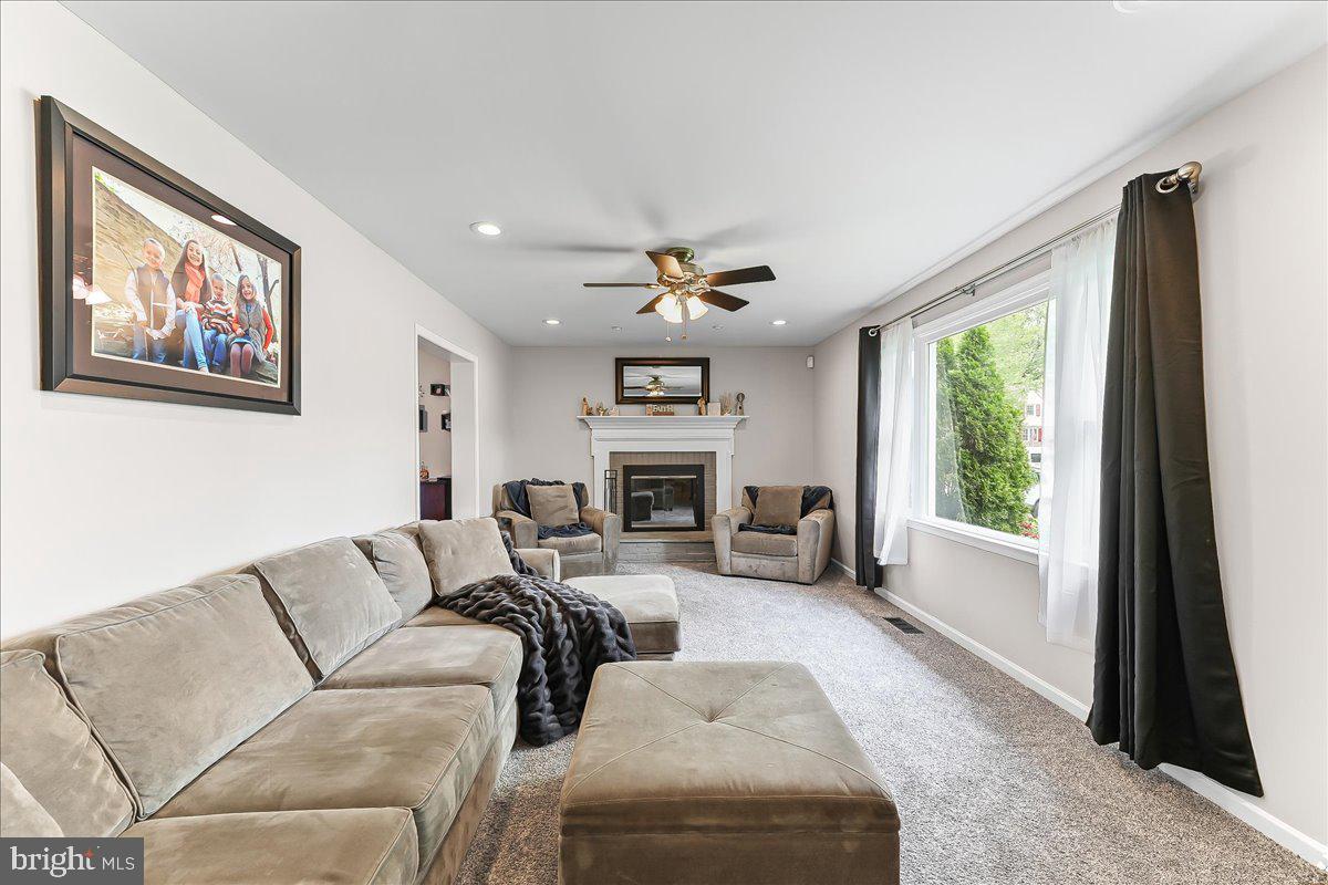 208 Rambling Way Springfield, PA 19064 - Photo 6 of 39 a living room with furniture large window and fireplace