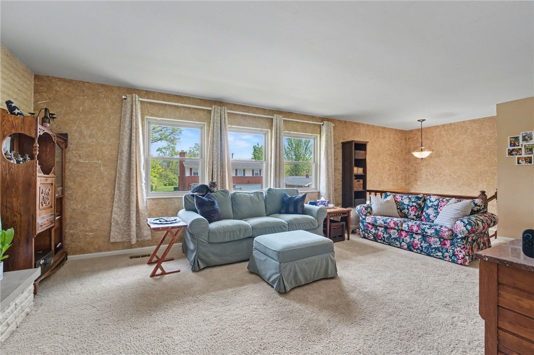 4919 Silver Arrow Drive Riverside, OH 45424 - Photo 10 of 57 This inviting living space features ample natural light and plush carpeting, perfect for comfortable gatherings.