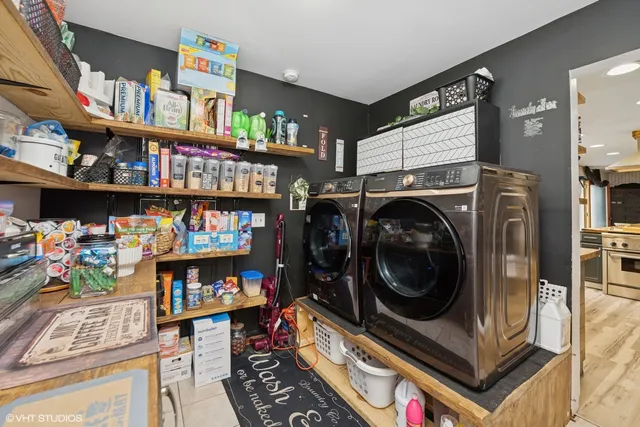 a utility room with lots of clutter and cabinets