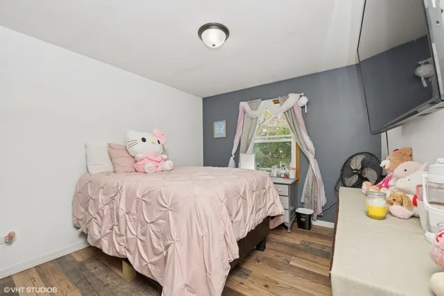 a bedroom with a bed and a window