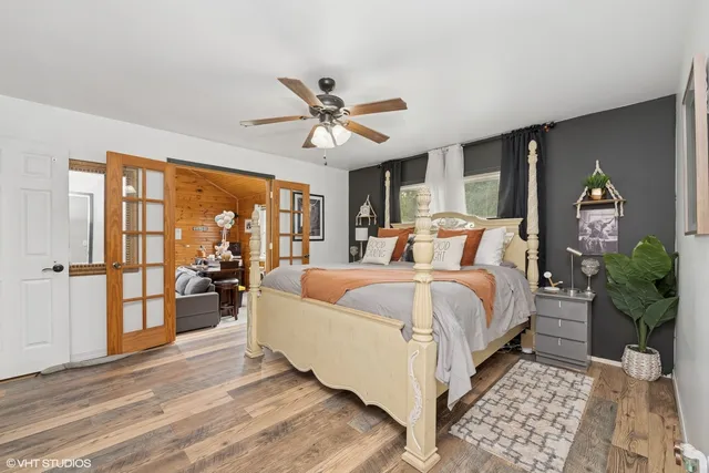 a bedroom with a large bed and a chandelier