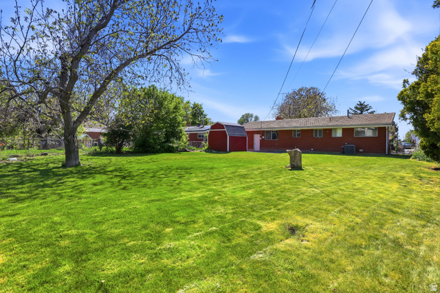 2348 North 770 West Clinton, UT 84015 - Photo 19 of 25 Expansive green lawn with mature shade trees