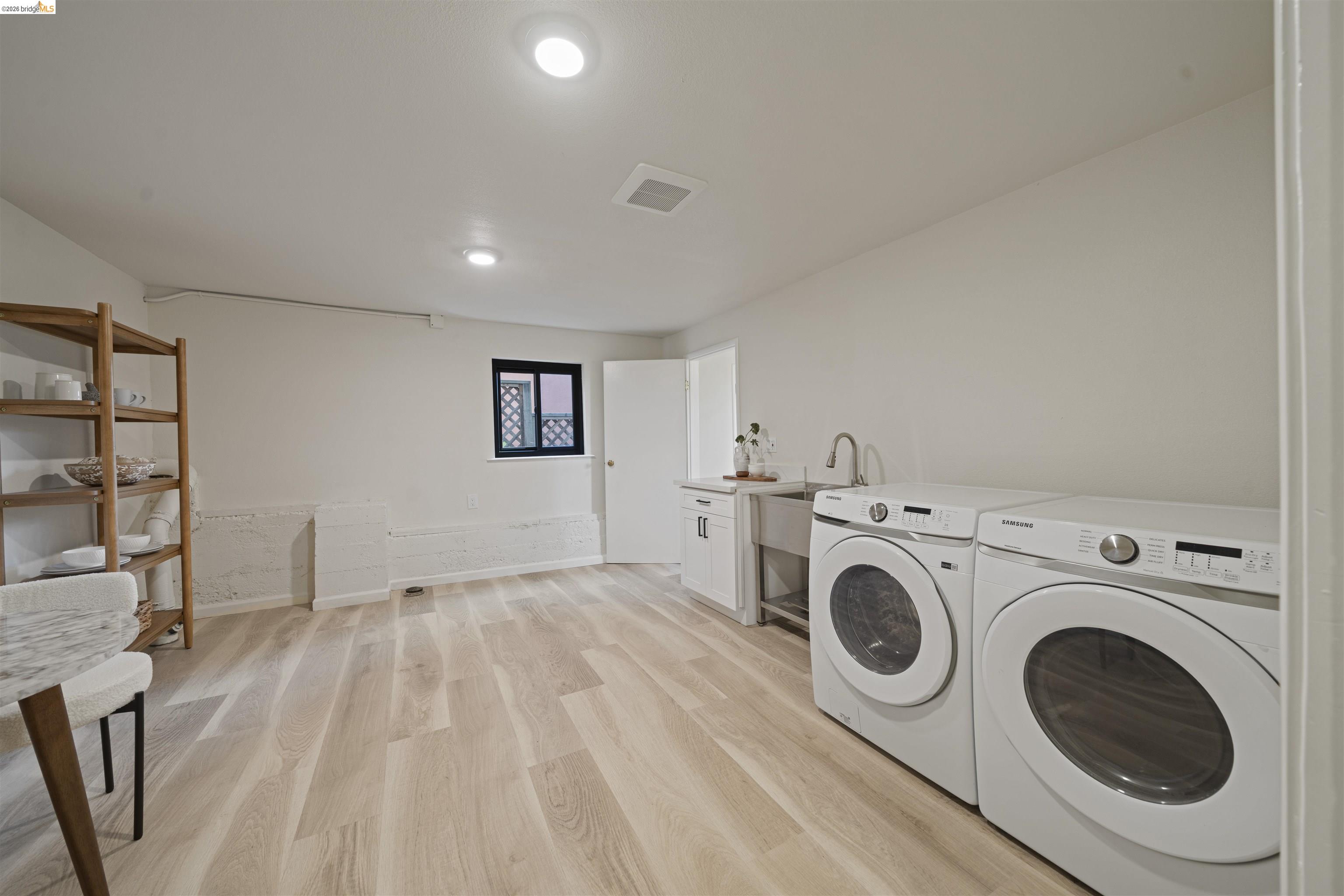 1170 Sterling Avenue Berkeley, CA 94708 - Photo 38 of 52 Laundry room with light wood finished floors, washing machine and clothes dryer, and recessed lighting