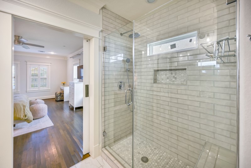 1122 East 23rd Street Houston, TX 77009 - Photo 12 of 23 Spa-inspired bathroom with oversized walk-in shower and sophisticated tilework.