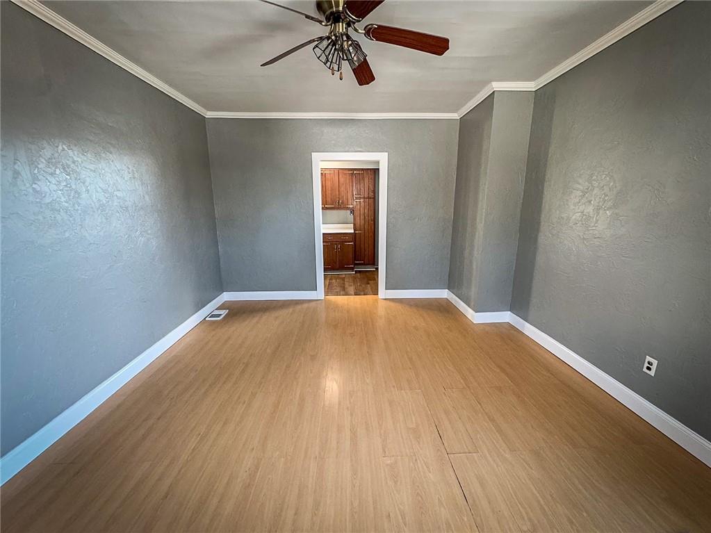 405 2nd Street Butler, PA 16001 - Photo 15 of 24 an empty room with wooden floor fan and windows