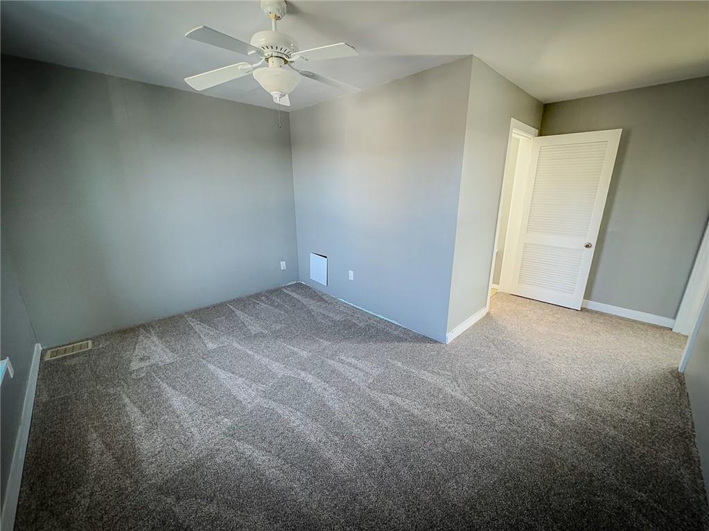 405 2nd Street Butler, PA 16001 - Photo 22 of 24 an empty room with a ceiling fan and a window