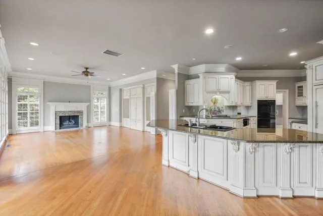 a large kitchen with kitchen island a sink stainless steel appliances and cabinets