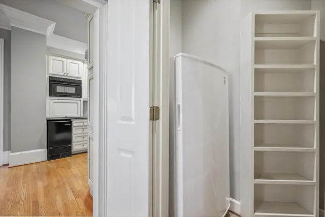 a bathroom with a refrigerator and a stove