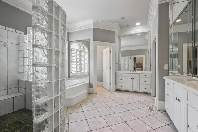 a spacious bathroom with a double vanity sink a mirror and a shower